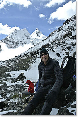 Michael enjoying a quick water break with a beautiful scenery on the background