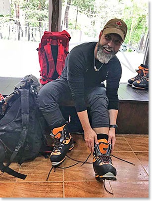 Shannon trying on double mountaineering boots at the rental shop