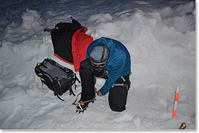 Jorg getting his crampons on before boarding the snowcat