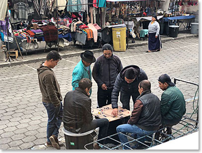 Locals playing a dice board game right outside the coffee shop window