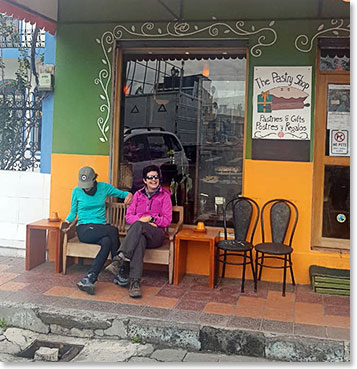 Andrea and Adriana sat down by a Pastry shop