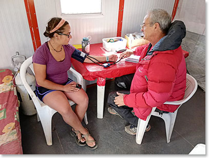 Kara getting her oxygen saturation, blood pressure, pulse rate checked.